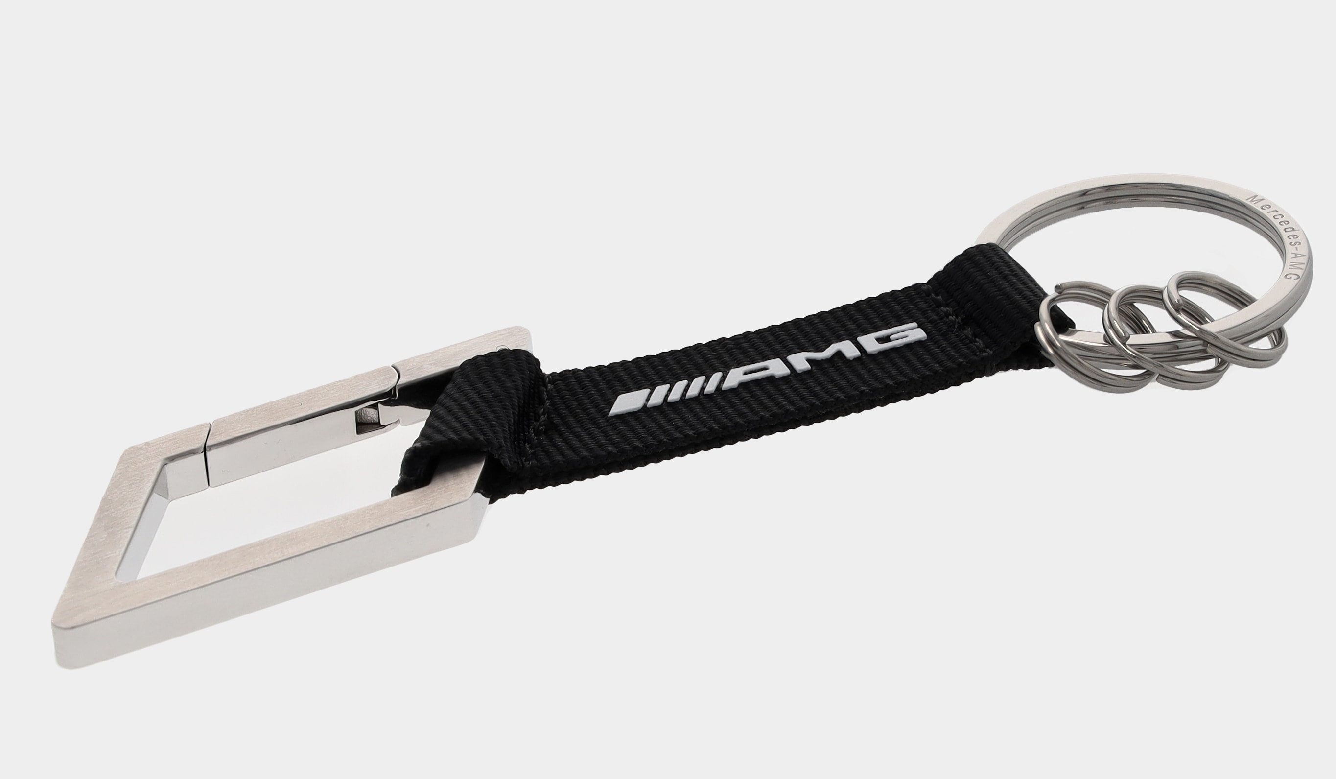 AMG Schlüsselanhänger, Karabiner - silberfarben / schwarz / weiß, Edelstahl / Nylon, gebürstet AMG Schlüsselanhänger, Karabiner - silberfarben / schwarz / weiß, Edelstahl / Nylon, gebürstet